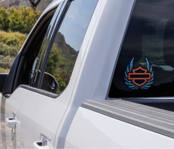 A window decal showing the Harley Davidson logo outline with no characters inside