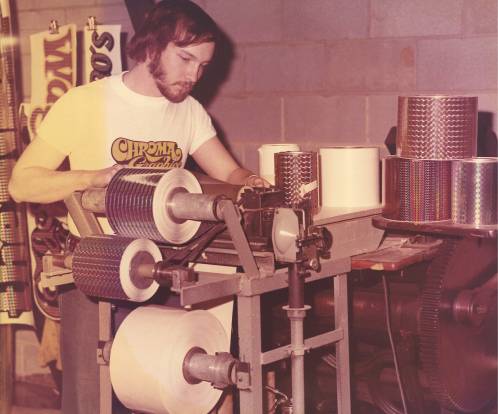 A man operating a printing machine