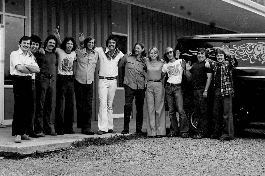 A team member photo with several members joyfully waving